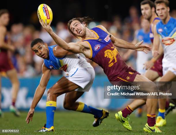 Rhys Mathieson of the Lions marks the ball over Touk Miller of the Suns during the 2017 AFL round 21 match between the Brisbane Lions and the Gold...