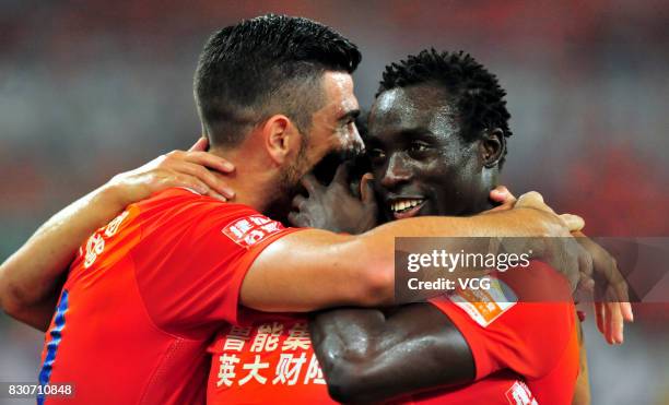 Graziano Pelle of Shandong Luneng celebrates a point with Papiss Demba Cisse of Shandong Luneng during the 22nd round match of 2017 Chinese Football...