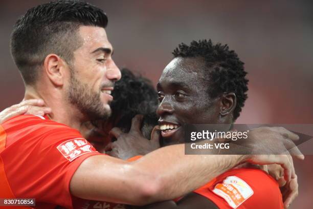 Graziano Pelle of Shandong Luneng celebrates a point with Papiss Demba Cisse of Shandong Luneng during the 22nd round match of 2017 Chinese Football...