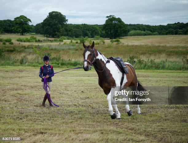 Woman exercises her horse before competing during the 194th Sedgefield Show on August 12, 2017 in Sedgefield, England. The annual show is held on the...