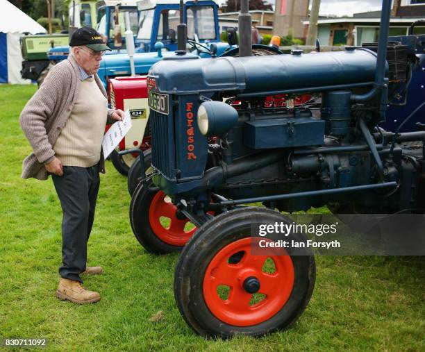 Man stands next to his vintage tractor during the 194th Sedgefield Show on August 12, 2017 in Sedgefield, England. The annual show is held on the...