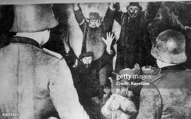 The Gestapo arrest a group of Jewish men hiding in a cellar in Poland, circa 1939. Possibly a staged German propaganda photo.