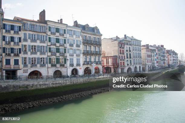 traditional architecture on nive river banks, bayonne, france - architectural cornice stock-fotos und bilder