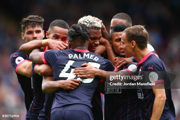 Steve Mounie of Huddersfield Town celebrates scoring his sides second goal with his Huddersield Town team mates during the Premier League match...