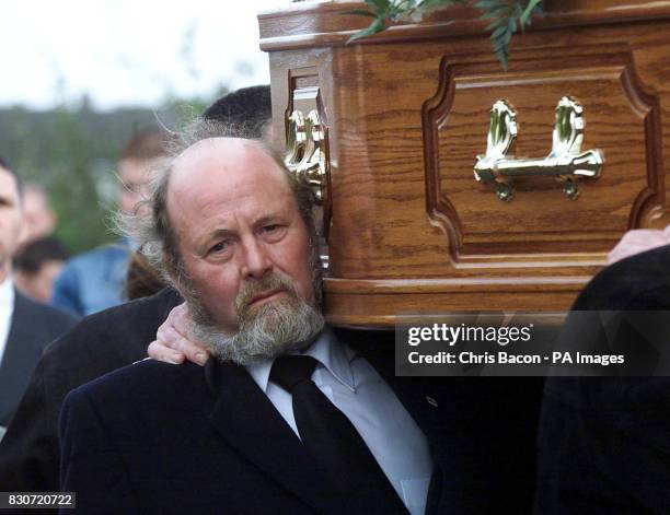 Fellow Sunday World journalist Jim Campbell who was shot by Loyalist in a gun attack in the 1980's, carries the coffin at the funeral of Sunday World...