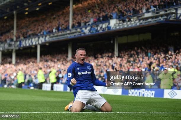 Everton's English striker Wayne Rooney celebrates scoring the opening goal during the English Premier League football match between Everton and Stoke...