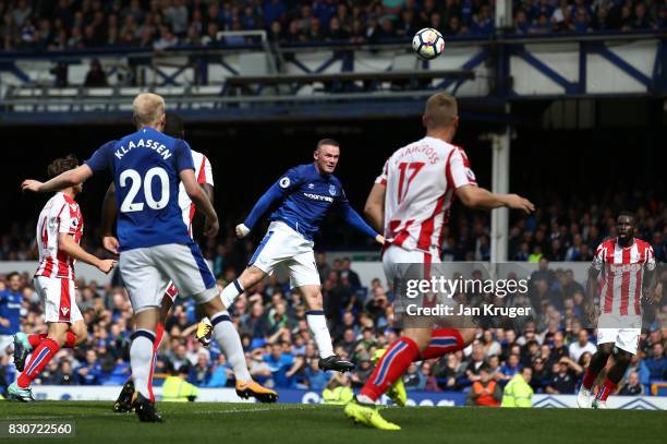 Wayne Rooney of Everton scores the opening goal during the Premier League match between Everton and Stoke City at Goodison Park on August 12, 2017 in...