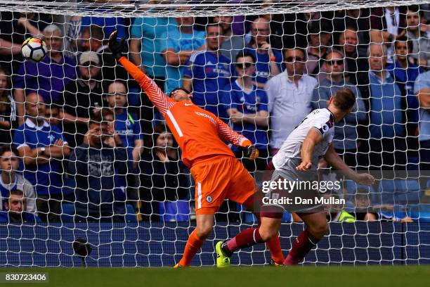 Sam Vokes of Burnley scores his sides third goal past Thibaut Courtois of Chelsea during the Premier League match between Chelsea and Burnley at...