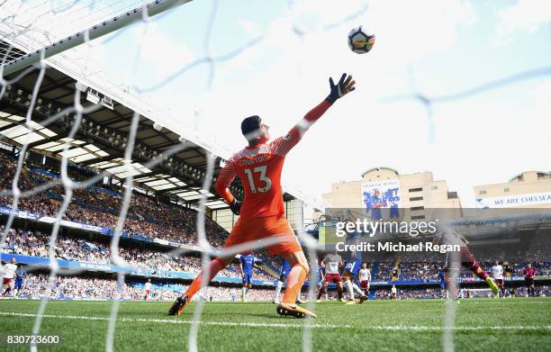 Sam Vokes of Burnley scores his sides third goal past Thibaut Courtois of Chelsea during the Premier League match between Chelsea and Burnley at...