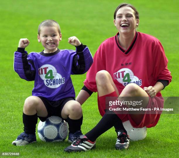 Five-year-old Jake Lunn from Ashford, Kent, with model Kate Groombridge during the launch of Kit 4 Schools at Tottenham's White Hart Lane ground in...