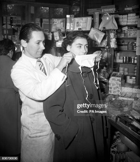 Sheila Glibbery of Ilford, Essex, was determined to suffer no ill effects from smog on her homeward journey.