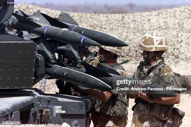 Members from the 26 Squadron RAF Regiment load a Rapier field Standard C Launcher with surface to air missiles while on exercise in the desert of...