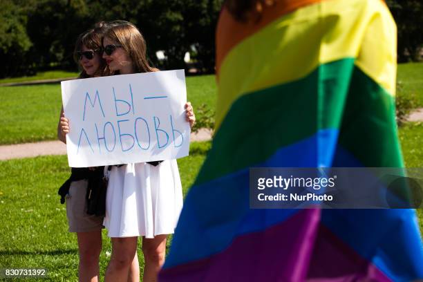 An activist holds a placard with a slogan &quot;We are love&quot; during St Petersburg LGBT Pride on august 12, 2017