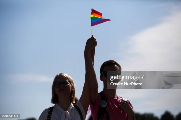Activists participate in the St Petersburg LGBT Pride march on august 12, 2017