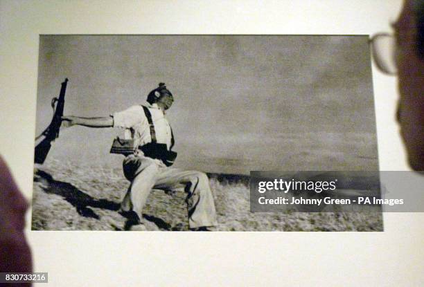 Bob Peters and son Rodney stare at Robert Capa's photograph, 'Death of a Militiaman' inside The Imperial War Museum's Spanish Civil War exhibition in...