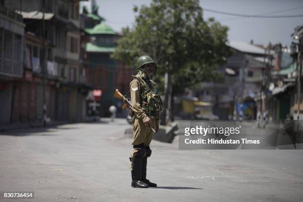 Paramilitary soldier stands guard during restrictions in a downtown area on August 11, 2017 in Srinagar, India. Authorities imposed restrictions in...