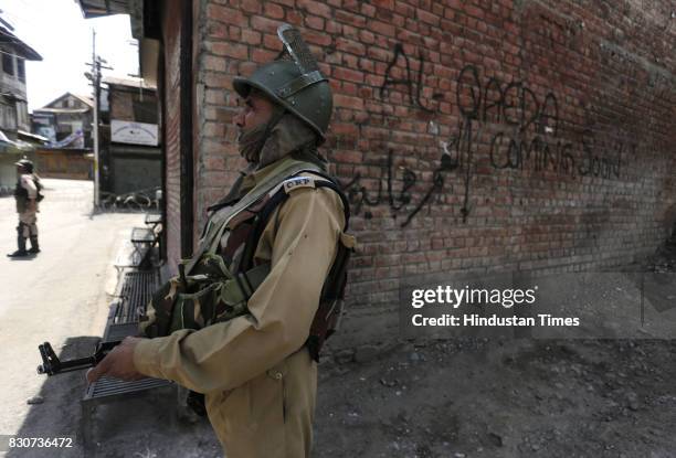 Paramilitary soldiers stand guard during restrictions in a downtown area on August 11, 2017 in Srinagar, India. Authorities imposed restrictions in...