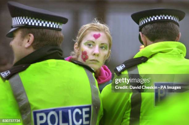 Protester looks down a police line at the anti-war and anti-nuclear demonstration at Faslane Naval Base in Scotland, where Britain's 4 nuclear...