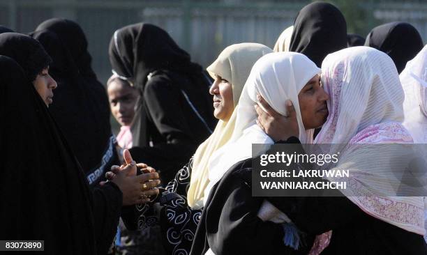 Sri Lankan Muslim women exchange Eid greetings after offering "Eid al-Fitr" prayers at a mosque in Colombo on October 1, 2008. Muslims around the...