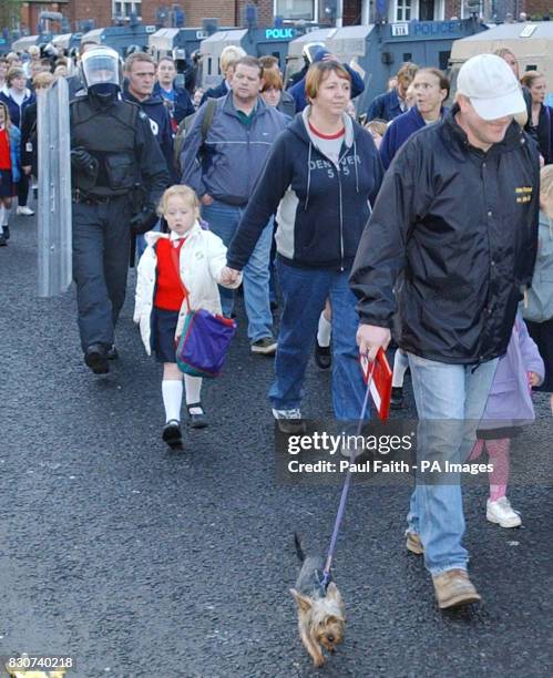 Children from Holy Cross Primary School in the Ardoyne area of Belfast are escorted by parents and RUC Officers in riot gear to school. Northern...