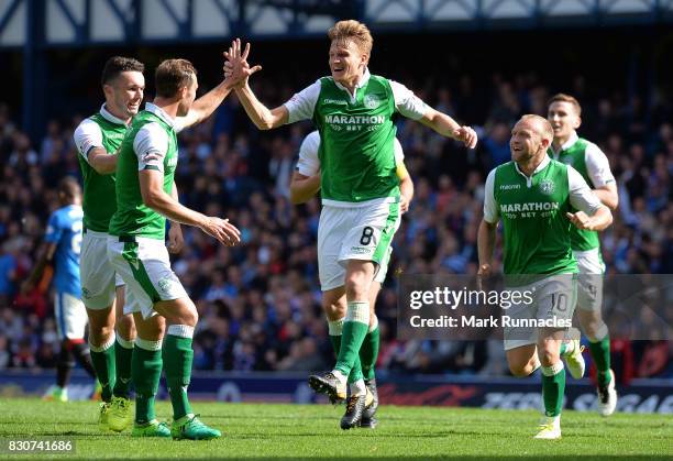 Vykintas Slivka , of Hibernian celebrates scoring with his team mates during the Ladbrokes Scottish Premiership match between Rangers and Hibernian...