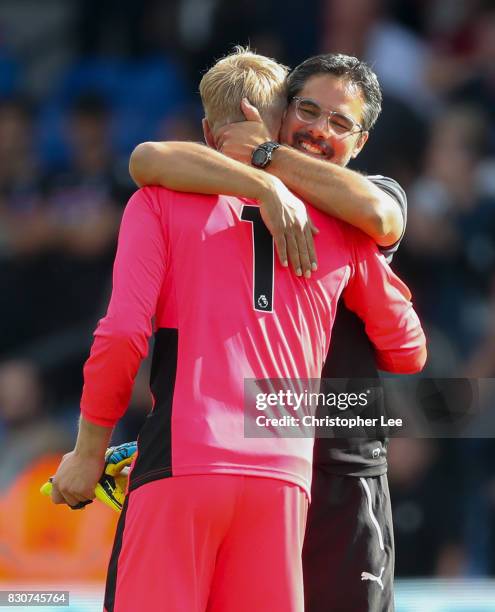 Jonas Lossl of Huddersfield Town and David Wagner, Manager of Hudersfield Town celebrate victory after the Premier League match between Crystal...
