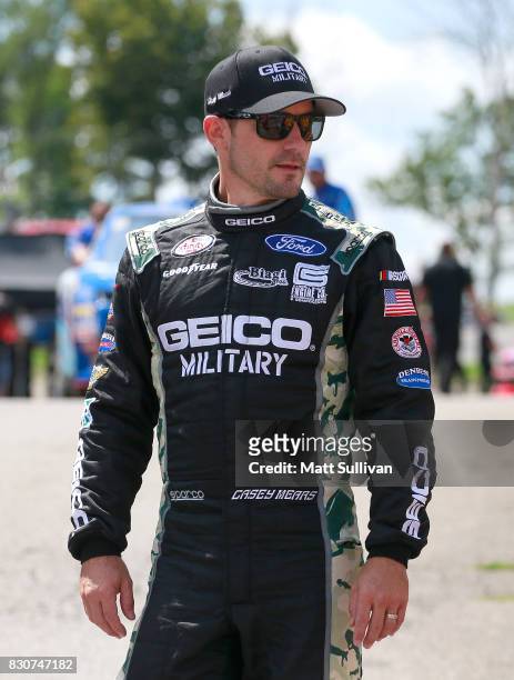 Casey Mears, driver of the GEICO Military Ford walks to his car prio to qualifying for the NASCAR XFINITY Series Mid-Ohio Challenge at Mid-Ohio...