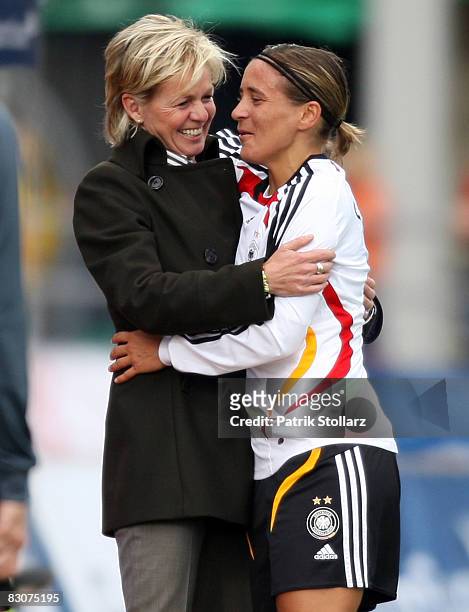 Head coach Silvia Neid holds Sandra Smisek of Germany after her last match for the national team during the 2009 UEFA European Championship...