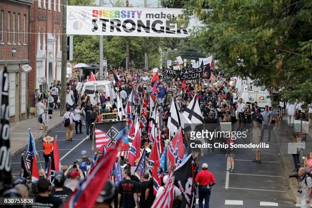Hundreds of white nationalists, neo-Nazis and members of the "alt-right" march down East Market Street toward Emancipation Park during the "Unite the...