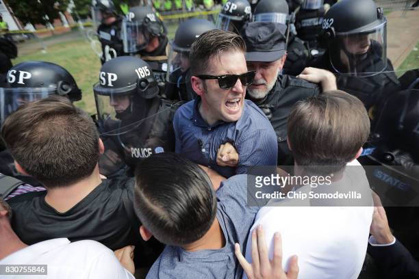 White nationalist Richard Spencer and his supporters clash with Virginia State Police in Emancipation Park after the "Unite the Right" rally was...