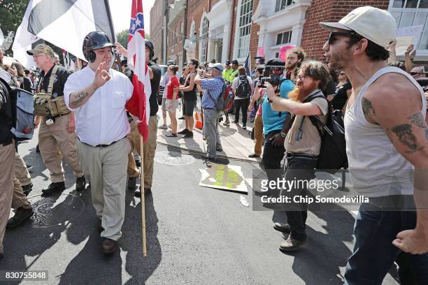 Hundreds of white nationalists, neo-Nazis and members of the "alt-right" are confronted by protesters as they march down East Market Street toward...