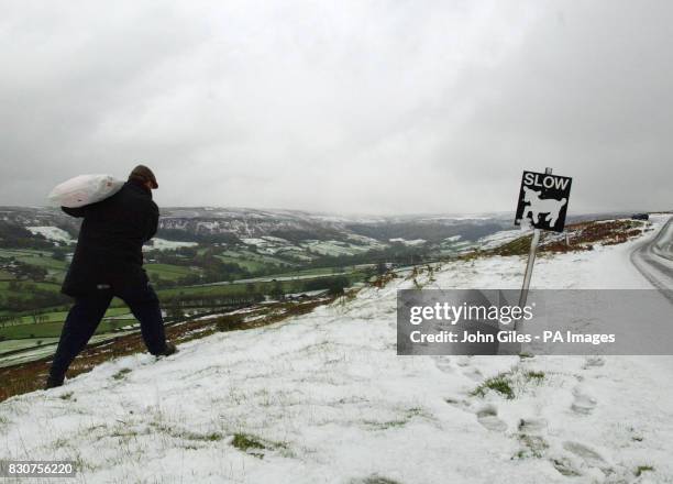 Feed for the sheep is carried in along snow-covered roads on the moorlands of Castleton, North Yorkshire, as the first snows of winter hit the...
