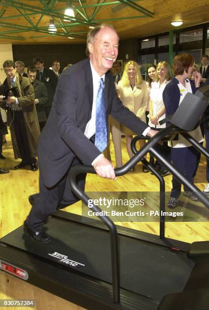 Contender for the position of Scottish First Minister Malcolm Chisholm takes a jog on an exercise machine whilst at the opening of a new...