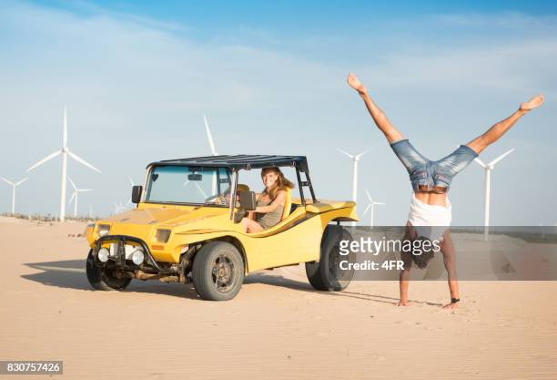 couple beach buggy fun, handstand, candid smile, brazil - dune buggy stock pictures, royalty-free photos & images