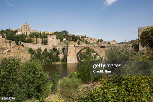 puente de san martín - famous historic bridge in toledo (castile–la mancha/ spain) - alcazar castle stock pictures, royalty-free photos & images
