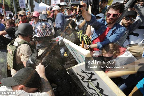White nationalists, neo-Nazis and members of the "alt-right" exchange vollys of pepper spray with counter-protesters as they enter Emancipation Park...