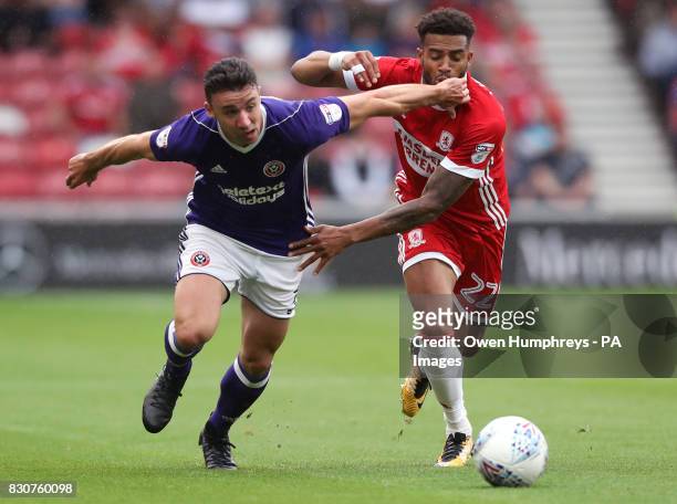 Sheffield United's Enda Stevens and Middlesbrough's Cyrus Christie battle for the ball during the Sky Bet Championship match at the Riverside...