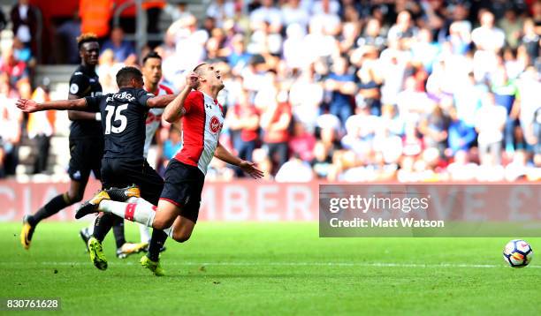 Southampton's Oriol Romeu feels the affects of a tackle from Swansea City's Wayne Routledge during the Premier League match between Southampton and...