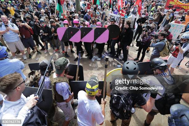 Battle lines form between white nationalists, neo-Nazis and members of the "alt-right" and anti-fascist counter-protesters at the entrance to...