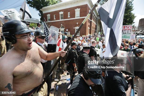 White nationalists, neo-Nazis and members of the "alt-right" exchange insluts with counter-protesters as they attempt to guard the entrance to...