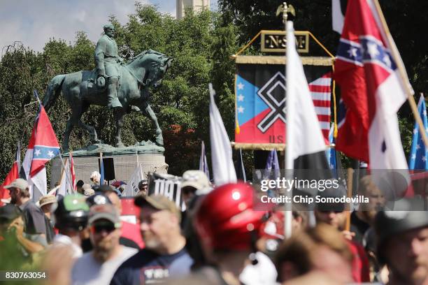 The statue of Confederate General Robert E. Lee stands behind a crowd of hundreds of white nationalists, neo-Nazis and members of the "alt-right"...