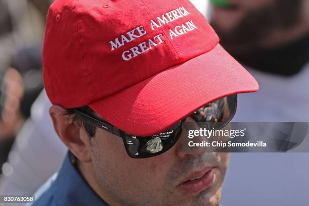 Man wears a 'Make America Great Again' hat during the "Unite the Right" rally August 12, 2017 in Charlottesville, Virginia. After clashes with...