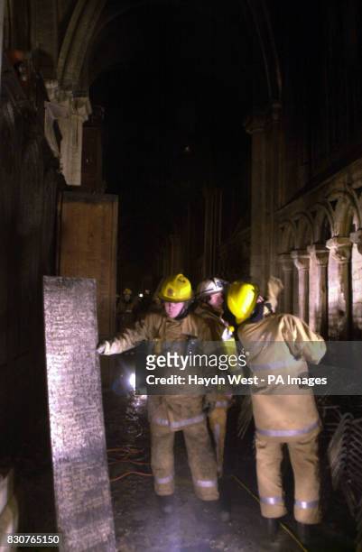 Firefighters assess the damage of one of Britain's oldest cathedrals following the blaze which was feared to have caused millions of pounds worth of...