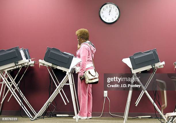 Woman casts her ballot absentee ballot using an electronic voting machine during early voting October 1, 2008 in Toledo, Ohio. "No fault" absentee...