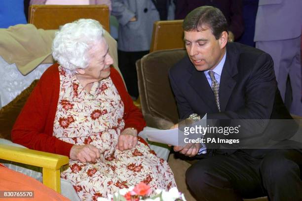 The Duke of York looks at an old school photo when he met his former dinnerlady, Emily Howells, during his days at Heatherdown School in Ascot in...