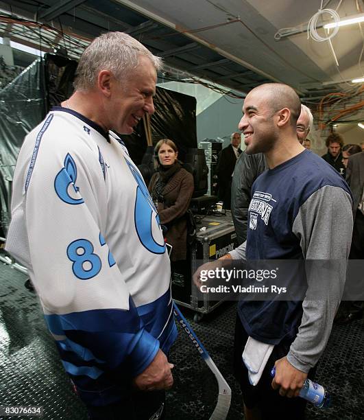 Russian ice hockey legend Viacheslav Fetisov speaks to a Rangers player Scott Gomez after the Victoria Cup Legends Match between Switzerland and...