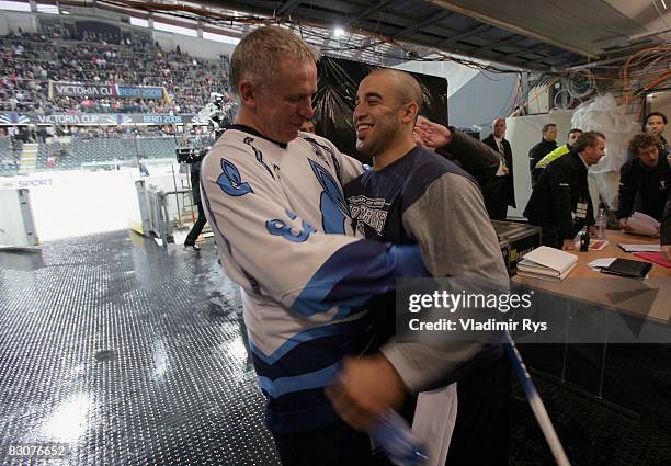 Russian ice hockey legend Viacheslav Fetisov speaks to a Rangers player Scott Gomez after the Victoria Cup Legends Match between Switzerland and...