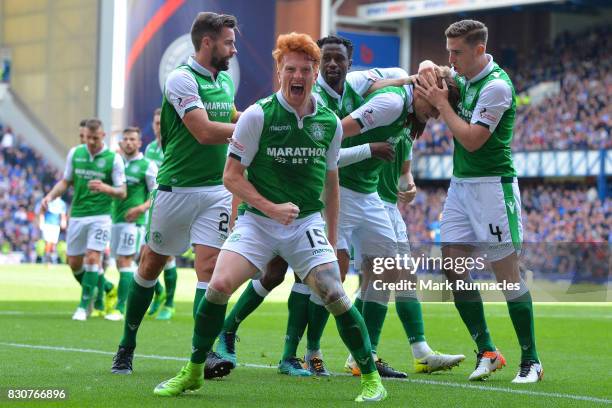 Simon Murray and fellow Hibernian plays celebrate their third goal during the Ladbrokes Scottish Premiership match between Rangers and Hibernian at...