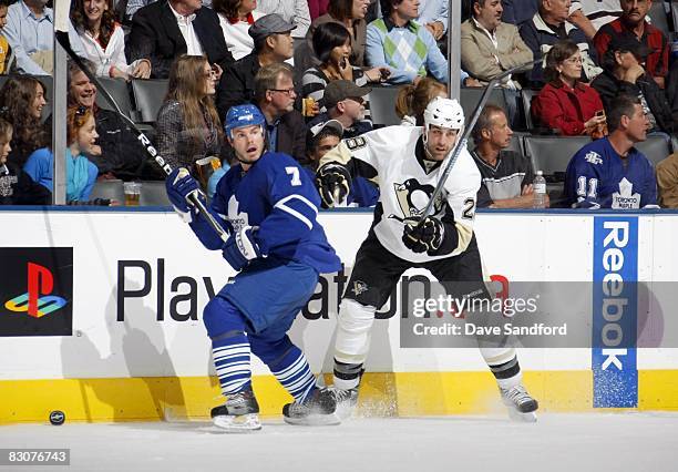 Eric Godard of the Pittsburgh Penguins looks on as Ian White of the Toronto Maple Leafs looks to center ice for the play during their pre-season NHL...