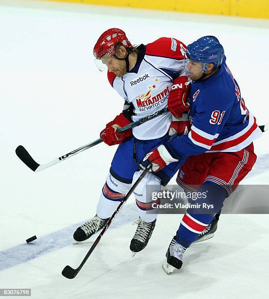 Rangers player Markus Naslund and Alexander Seluyanov of Metallurg battle for the puck during the Victoria Cup game between Metallurg Magnitogorsk...